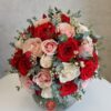 peach, red, white roses in a glass vase